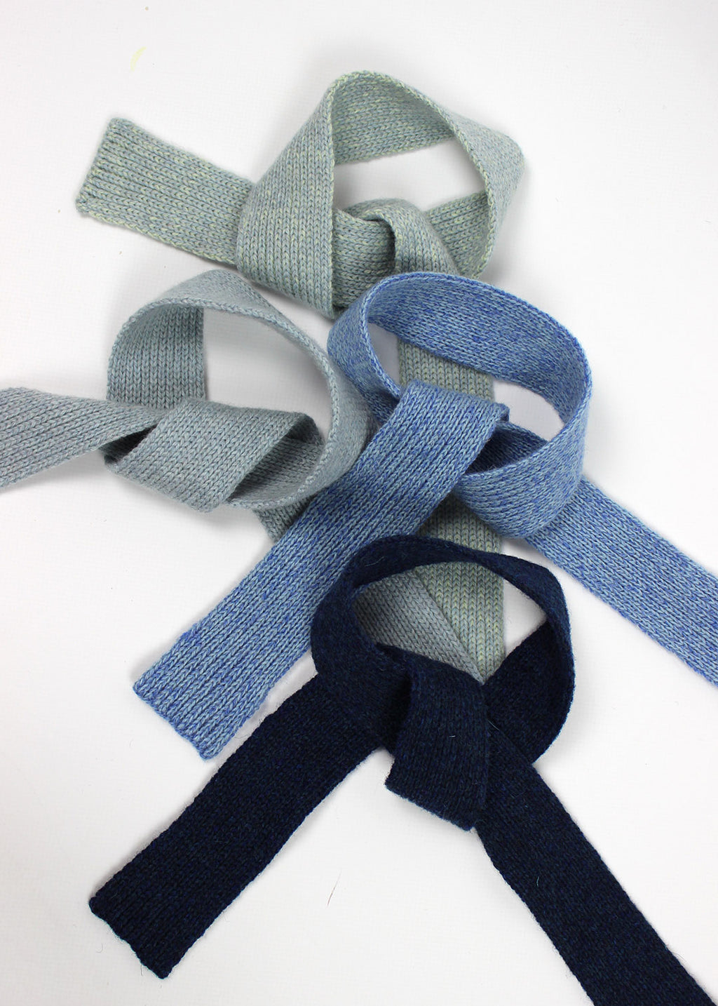 Knitted wool neck ties in range of blue 
colours.