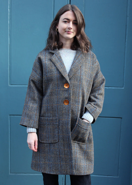 Classic ladies Harris Tweed coat in a traditional grey and brown herringbone check.