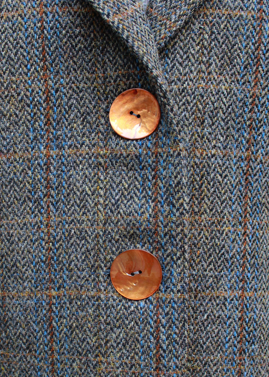 Classic ladies Harris Tweed coat in a traditional grey and brown herringbone check.