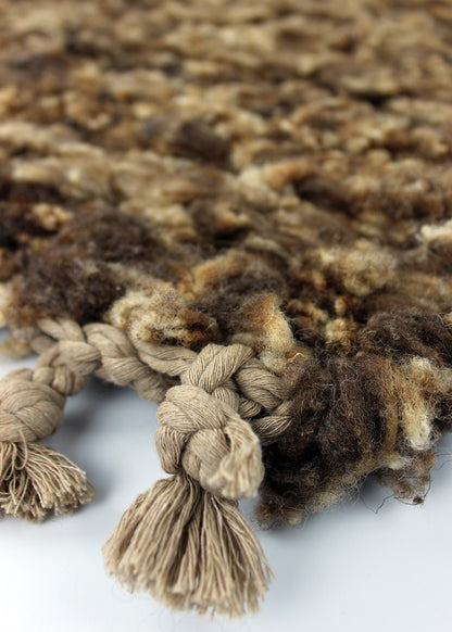 Hand woven sheep fleece rug in natural caramel tones.