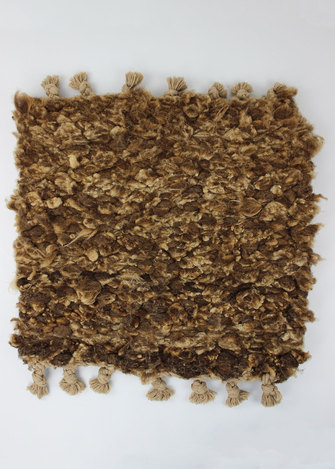 Hand woven sheep fleece rug in natural caramel tones.