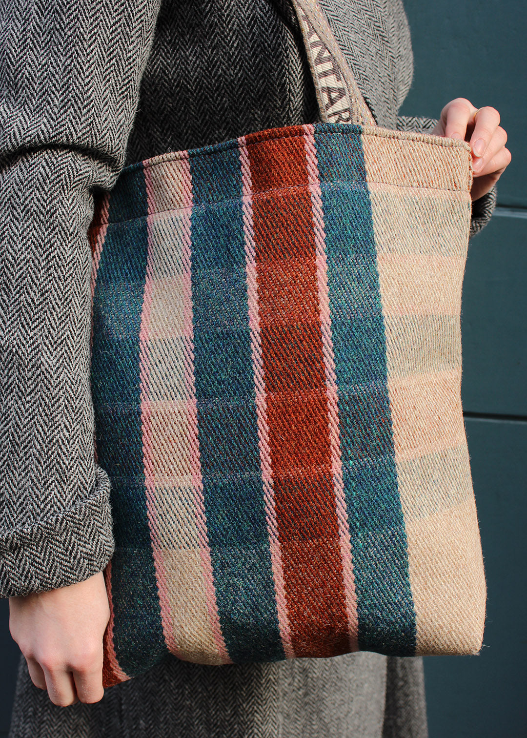 The Flora bag is woven in a teal, rust, oatmeal and pale pink check.