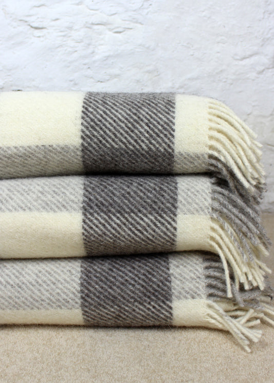 Grey and white checked blanket with tassels. Scottish Textiles Showcase.