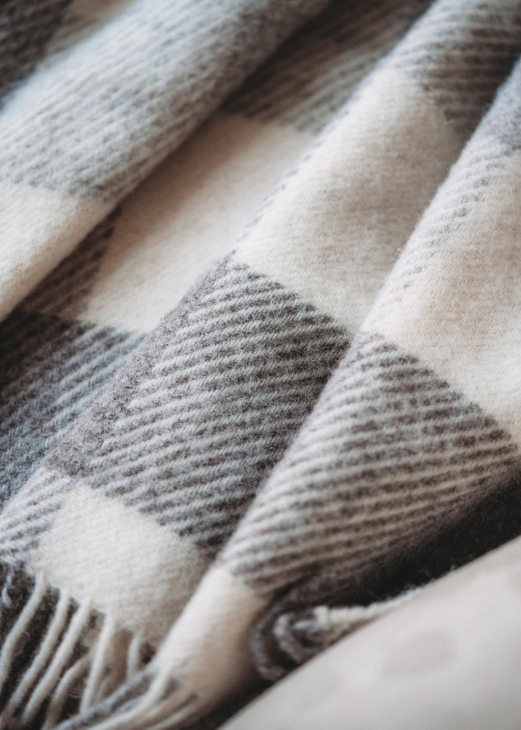Close-up of a checked blanked in Jacob wool.