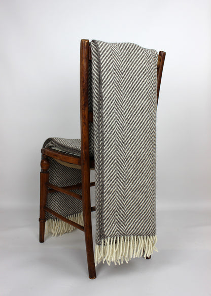 Grey Jacob throw on a chair. Scottish Textiles Showcase.