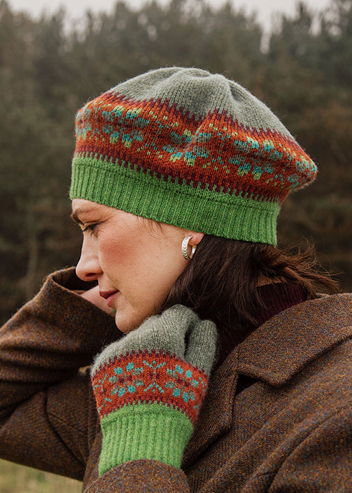 Beret knitted in shades of green and rust orange.