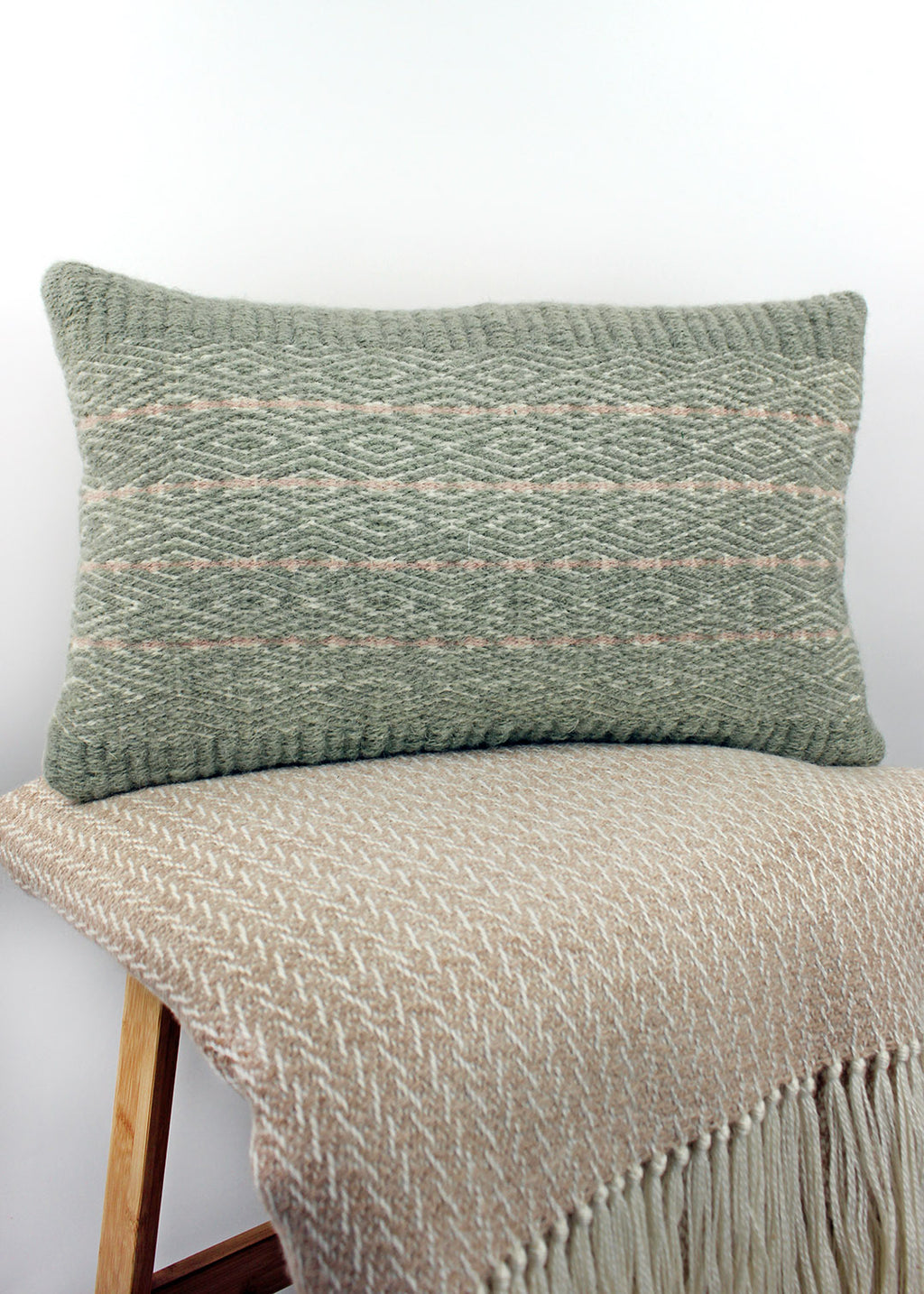 Limited edition, handwoven wool cushion in sage green and blush pink. Made in Edinburgh by spinner, dyer and weaver Kristina Taylor.