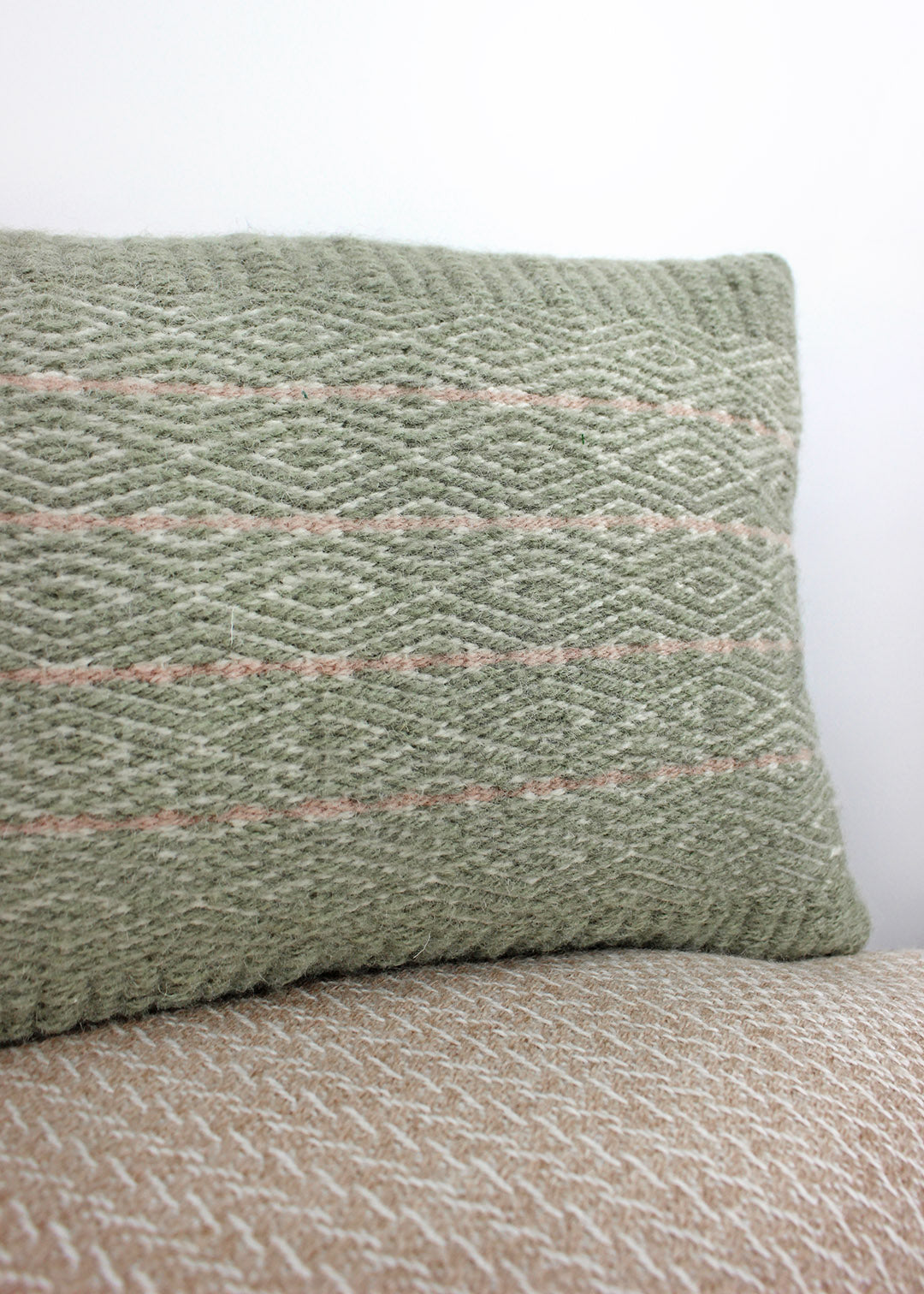 Limited edition, handwoven wool cushion in sage green and blush pink. Made in Edinburgh by spinner, dyer and weaver Kristina Taylor.