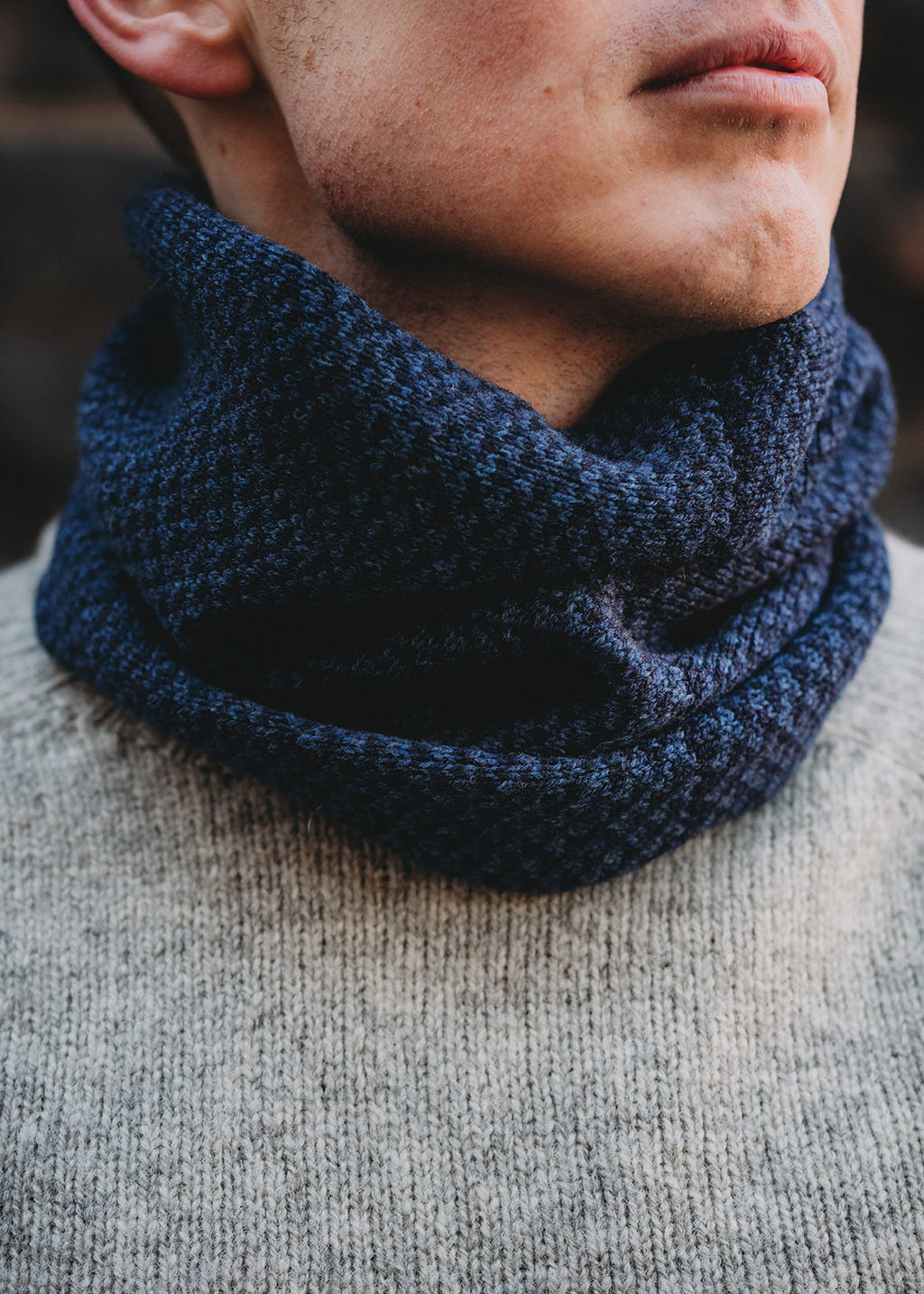 Lambswool knitted neck warmer shown on model.