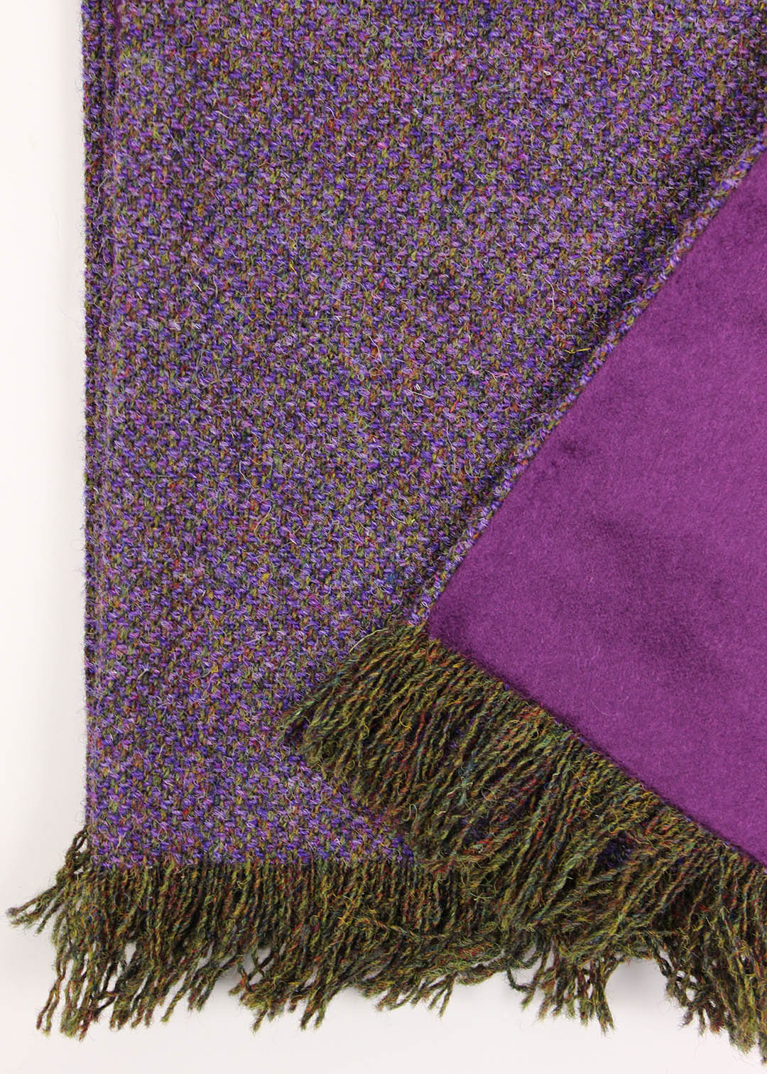 Our limited edition Harris scarf is made up of hand woven tweed in a myriad of purple hues like Scottish heather, paired with a soft cashmere reverse in deep purple.