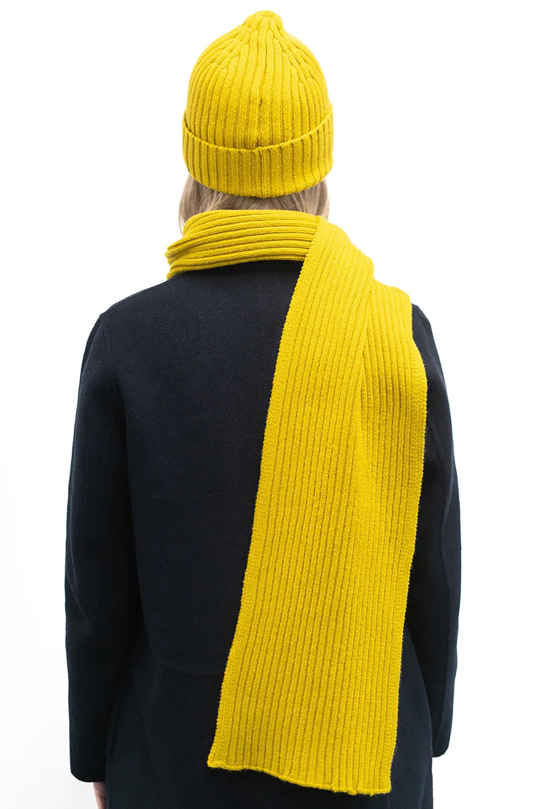 This scarf is a timeless classic with a ribbed knit structure in a bright mustard yellow. Made from the finest grade lambswool spun in Kinross, Scotland.