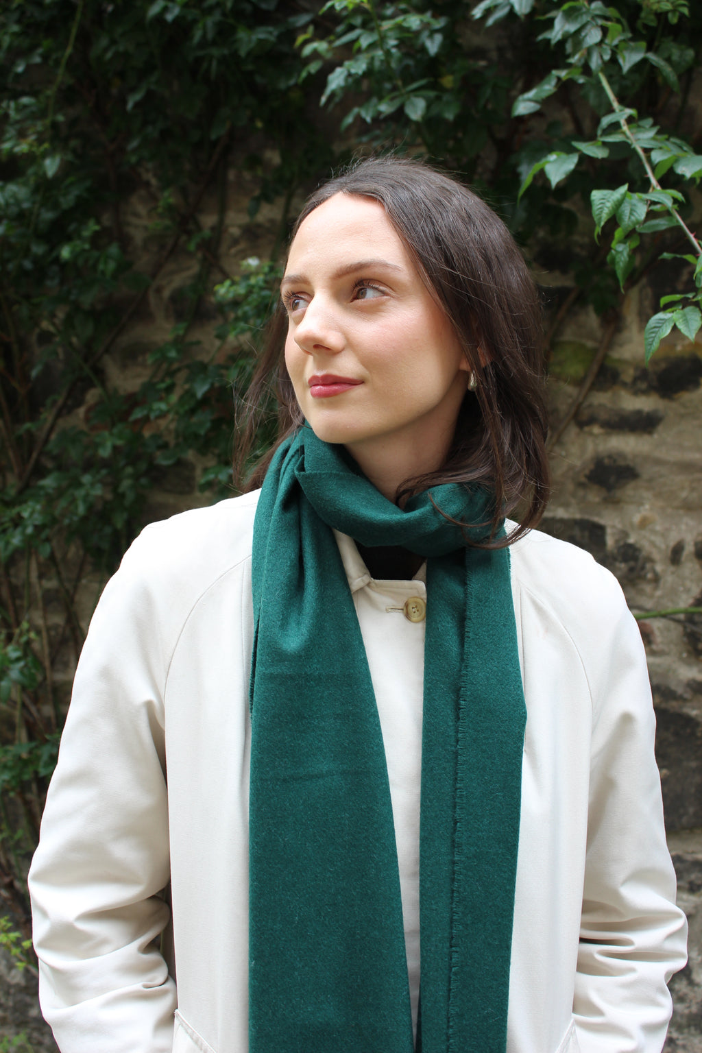 Cashmere scarf in forest green shown on model. 