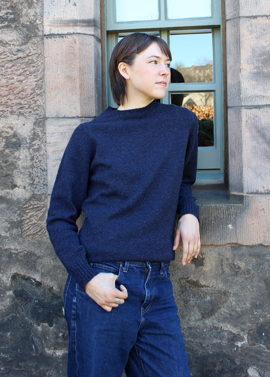 Lambswool jumper in indigo navy shown on model. Scottish Textiles Showcase.
