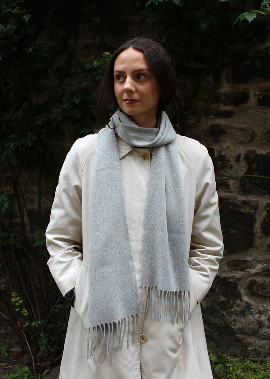 Light grey cashmere scarf shown on model. 