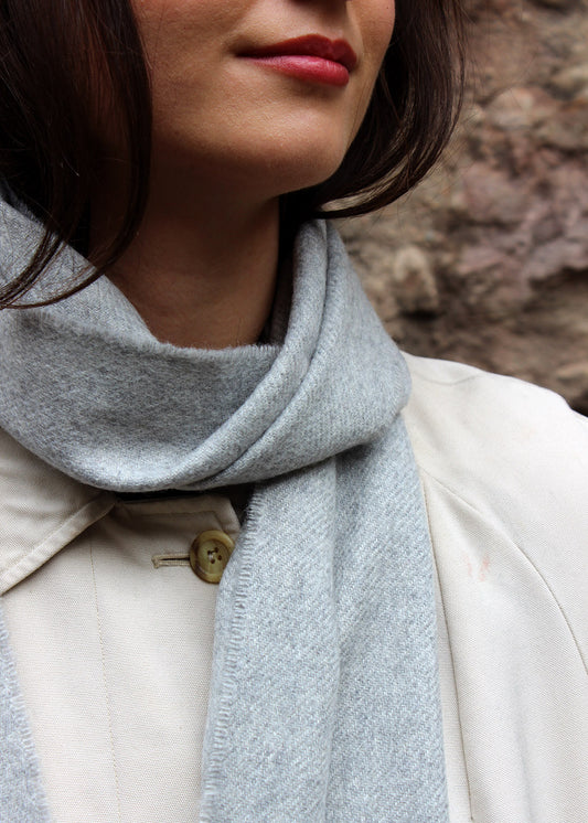 Light grey cashmere scarf shown on model. 