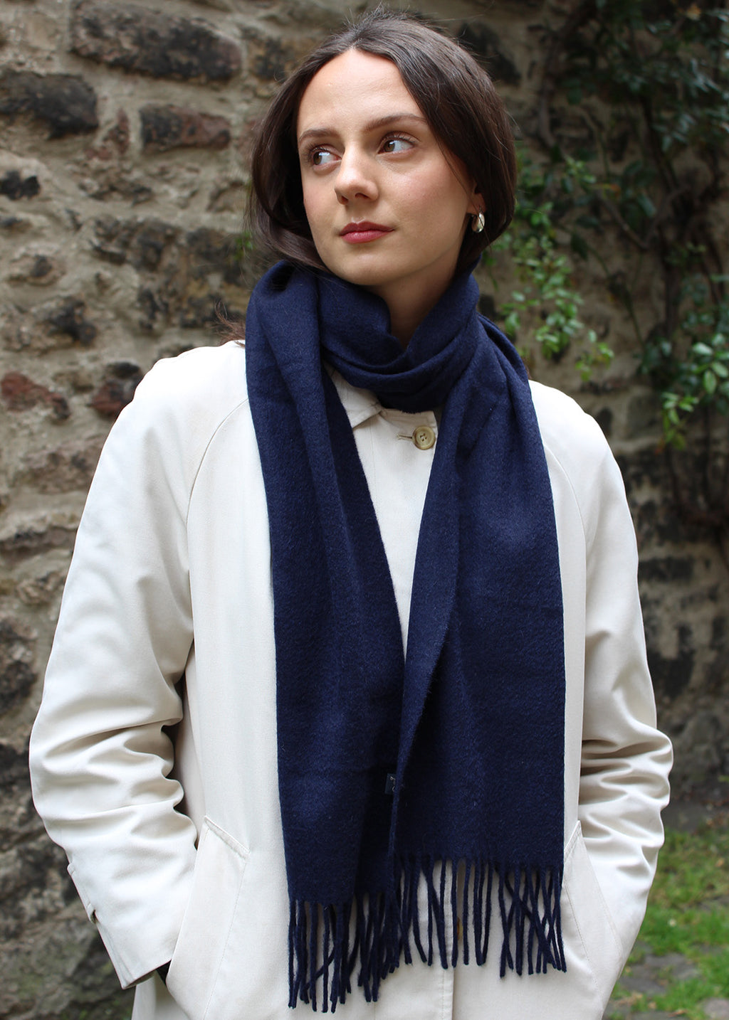 Cashmere scarf in navy shown on model. 
