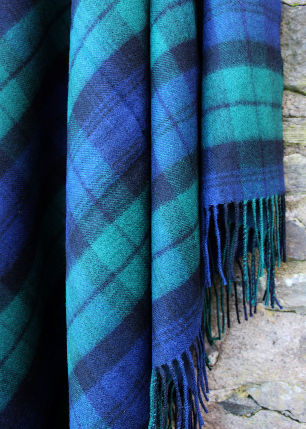 Lambswool tartan blanket woven in iconic navy, black and bottle green of the Black Watch tartan. Made in the Scottish Borders. Scottish Textiles Showcase.