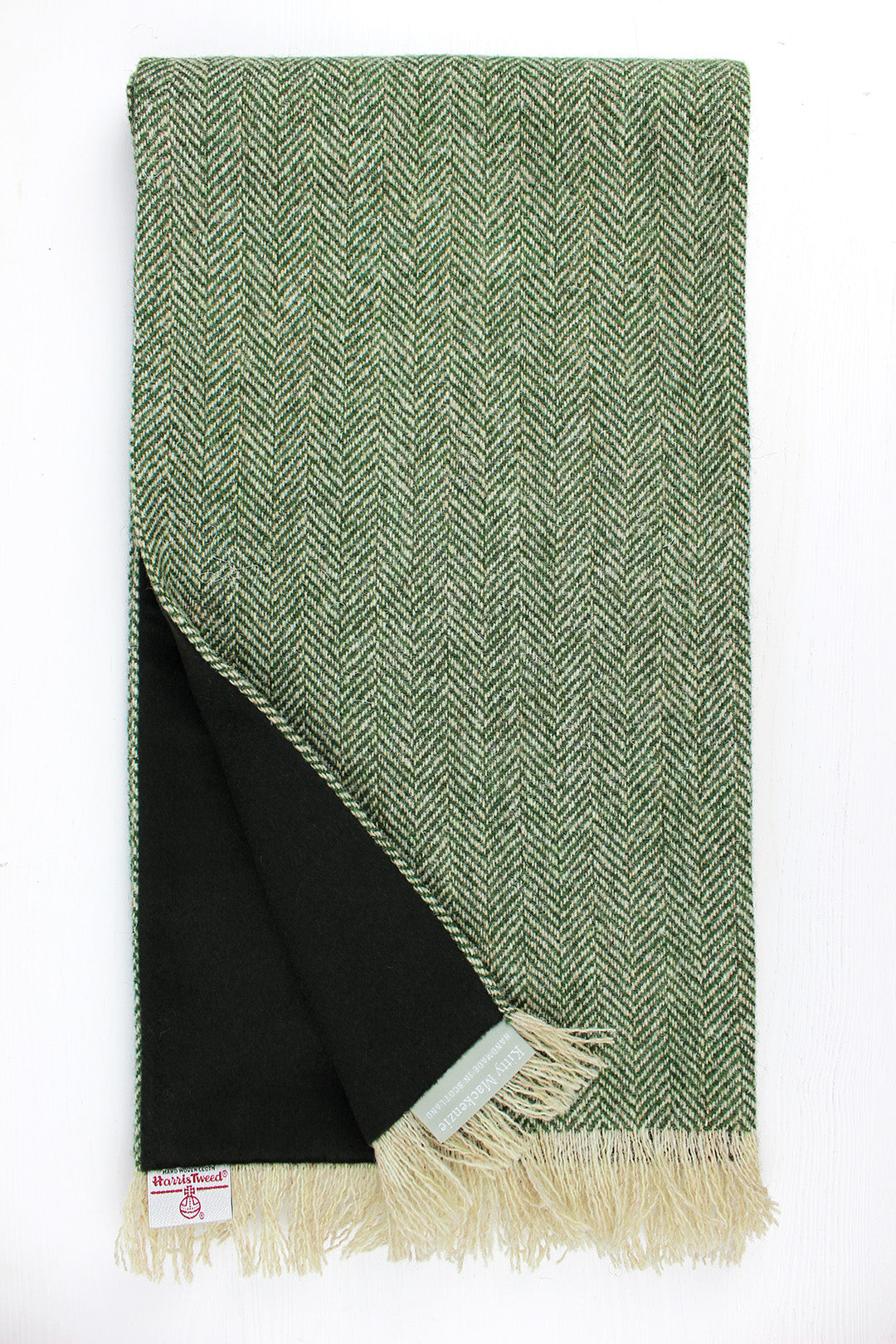 Harris tweed scarf  in green herringbone, lined with a dark green cashmere. Made in Scotland