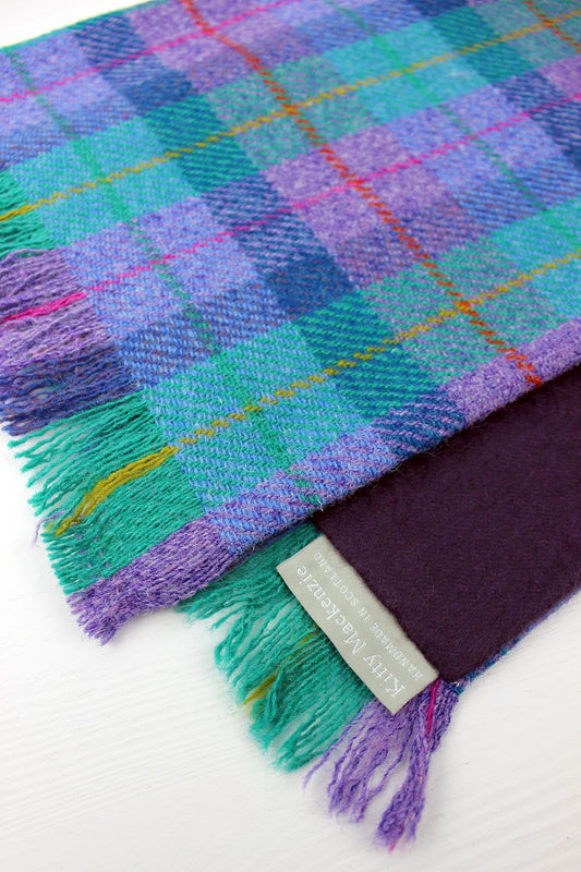 Western Isles scarf made from Harris Tweed woven in a glorious hue of purples and turquoise, lined with a deep purple cashmere.