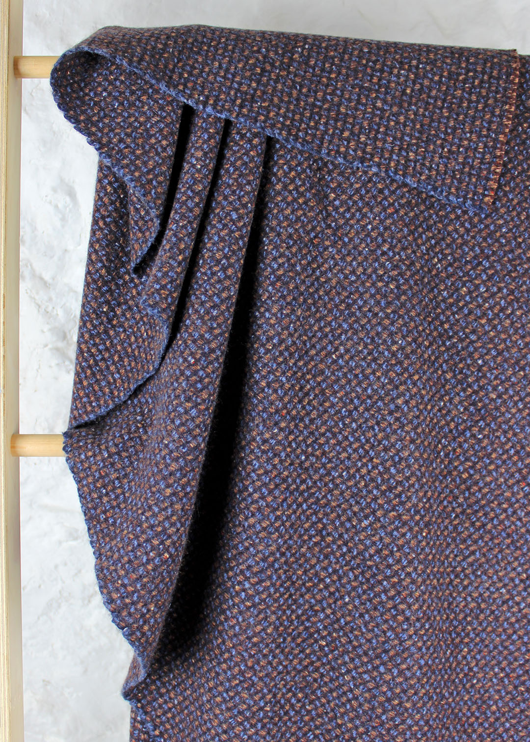 Pure cashmere throw in a subtle waffle texture woven in blues, browns and maroon