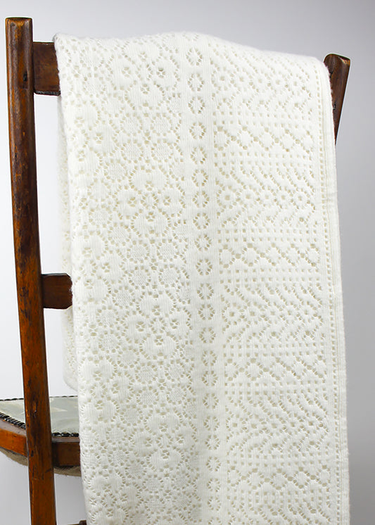 An ivory cotton lace baby shawl, photographed with teddy. Scottish Textiles Showcase.