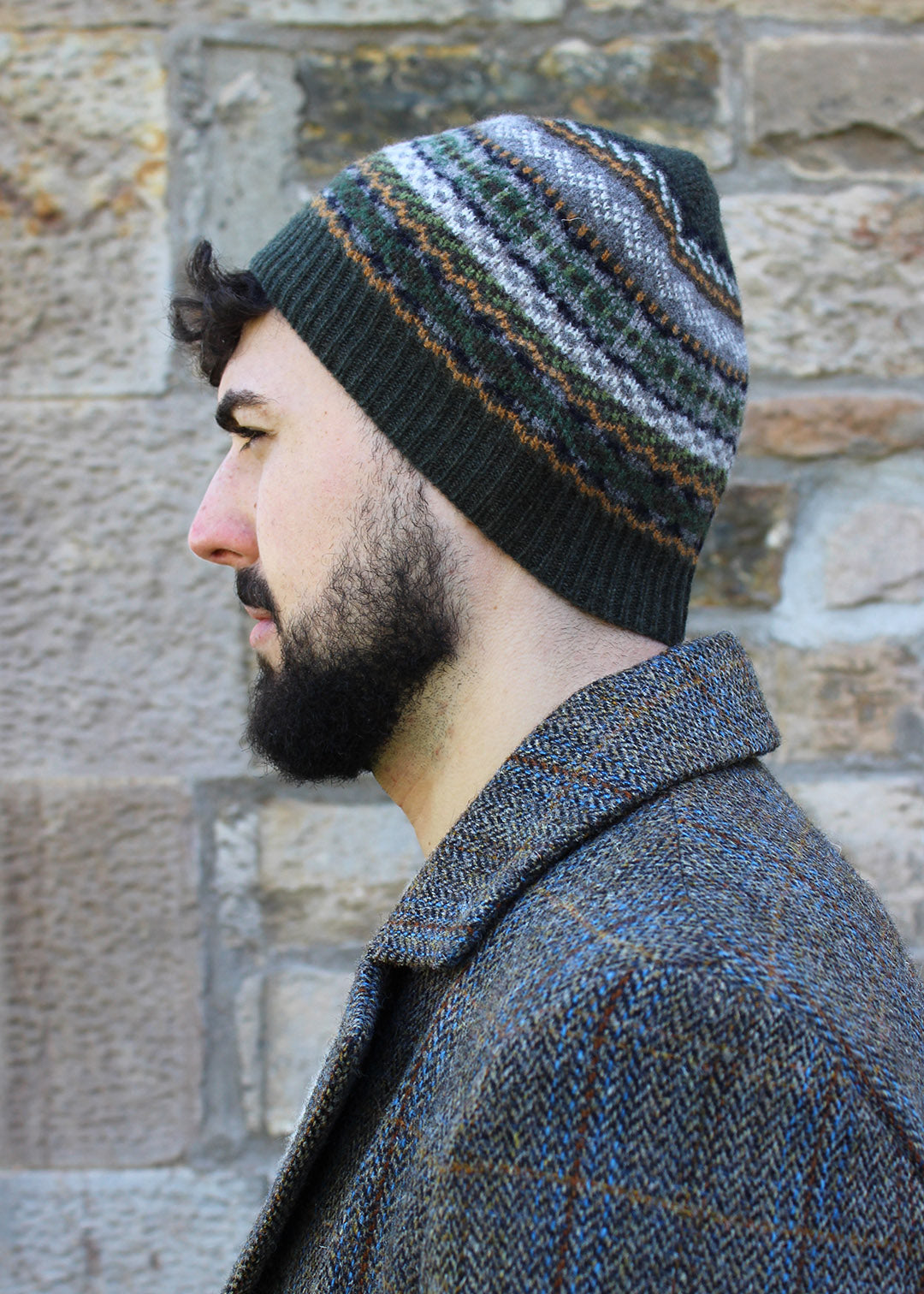 Lambwsool fairisle hat in khaki shown on model. Scottish Textiles Showcase.