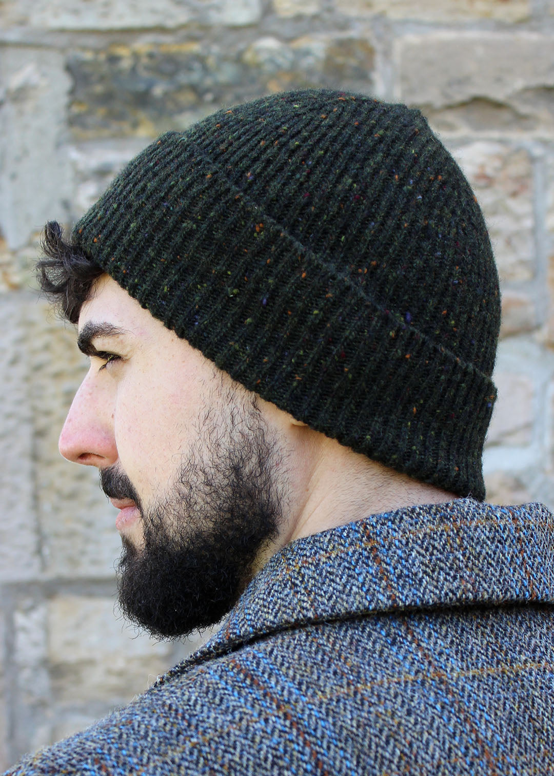 Classic ribbed beanie knitted in ivy green with speckles of burnt umber, red and green. Scottish Textiles Showcase.