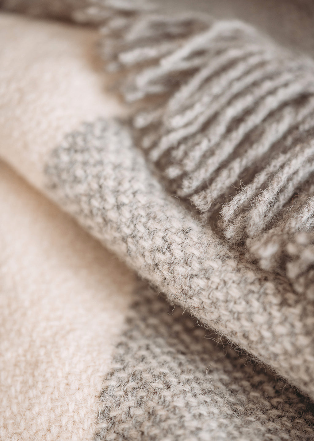 Handwoven Falkland Estate blanket in natural grey and off white.