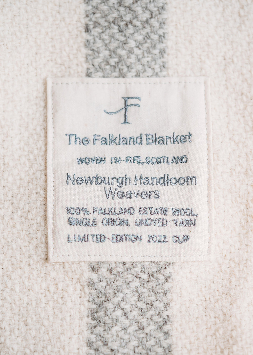 Handwoven Falkland Estate blanket in natural grey and off white.