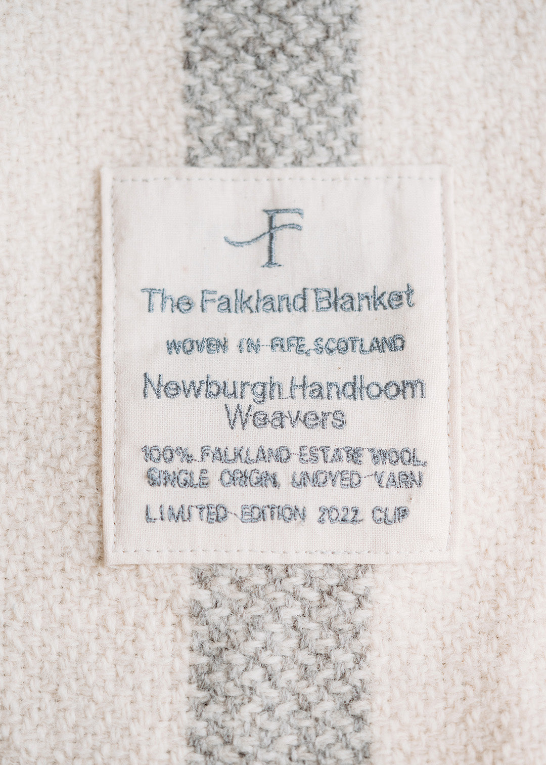 Handwoven Falkland Estate blanket in natural grey and off white.