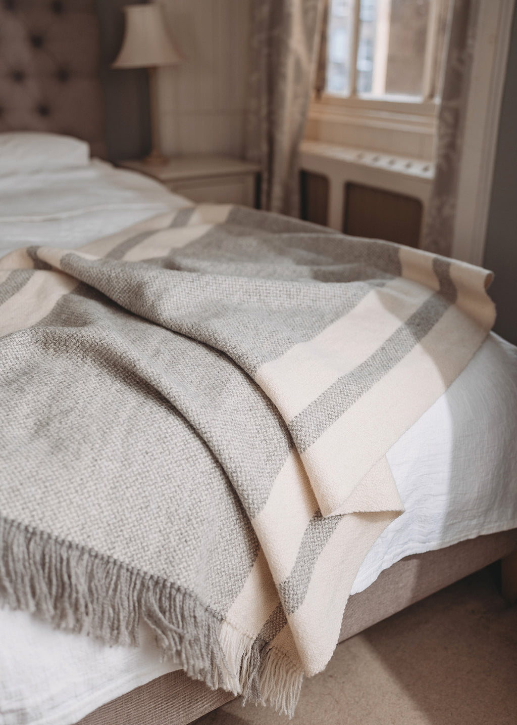 Handwoven Falkland Estate blanket in natural grey and off white.