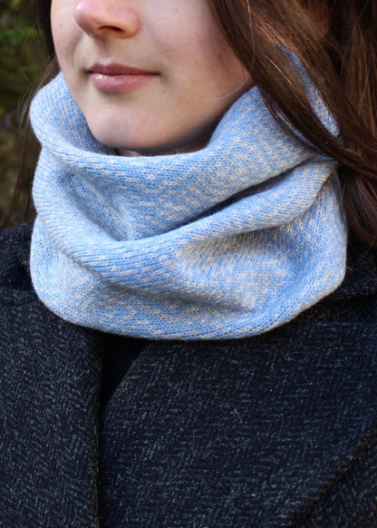 Merino lambswool neck warmer in pale blue and grey with a design inspired by map contours.