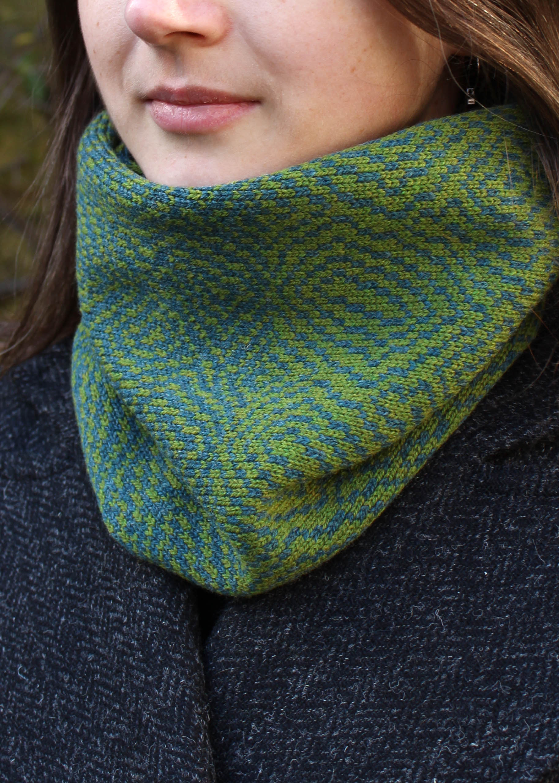 Merino lambswool neck warmer in shades of moss green with a design inspired by map contours.