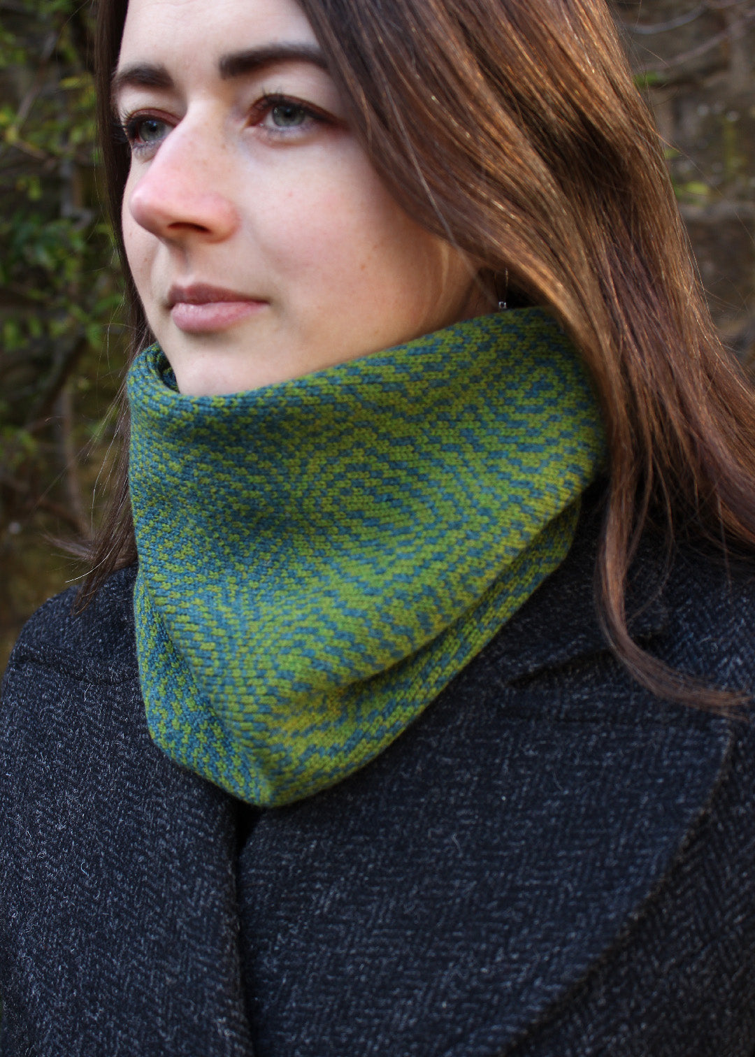 Merino lambswool neck warmer in shades of moss green with a design inspired by map contours.
