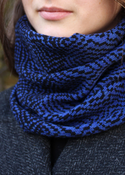 Merino lambswool neck warmer in Persian blue and black with a design inspired by map contours.