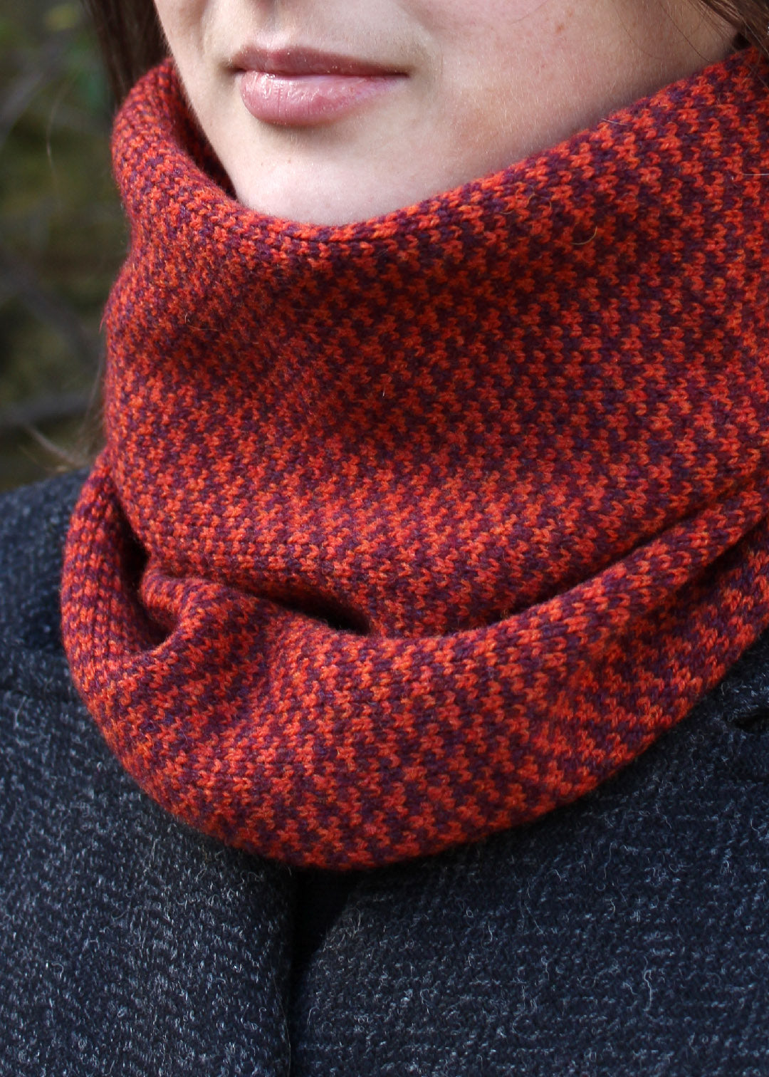 Merino lambswool neck warmer in rust and burgundy with a design inspired by the Hebridean sea on the crossing to the Isle of Harris.