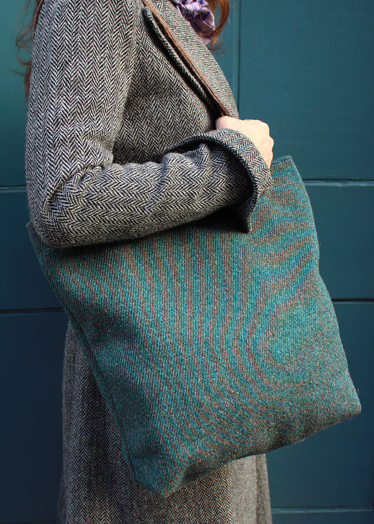 The Peacock bag is woven in a diagonal twill in teal with a subtle rust stripe