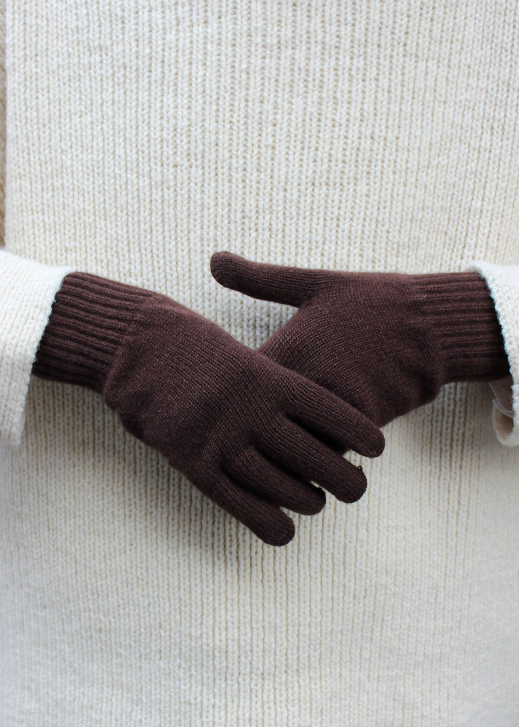 Pair of brown cocoa cashmere gloves on model.