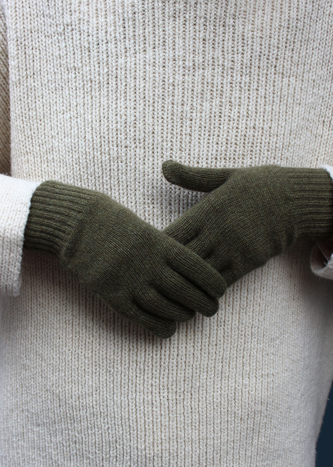 Pair of khaki cashmere gloves on model.