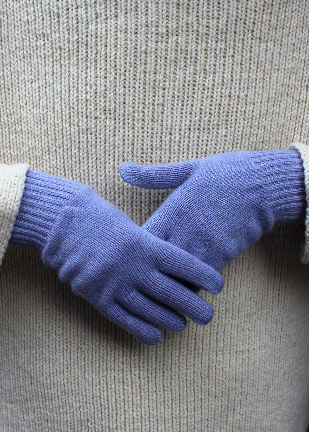 Pair of lavender cashmere gloves on model.