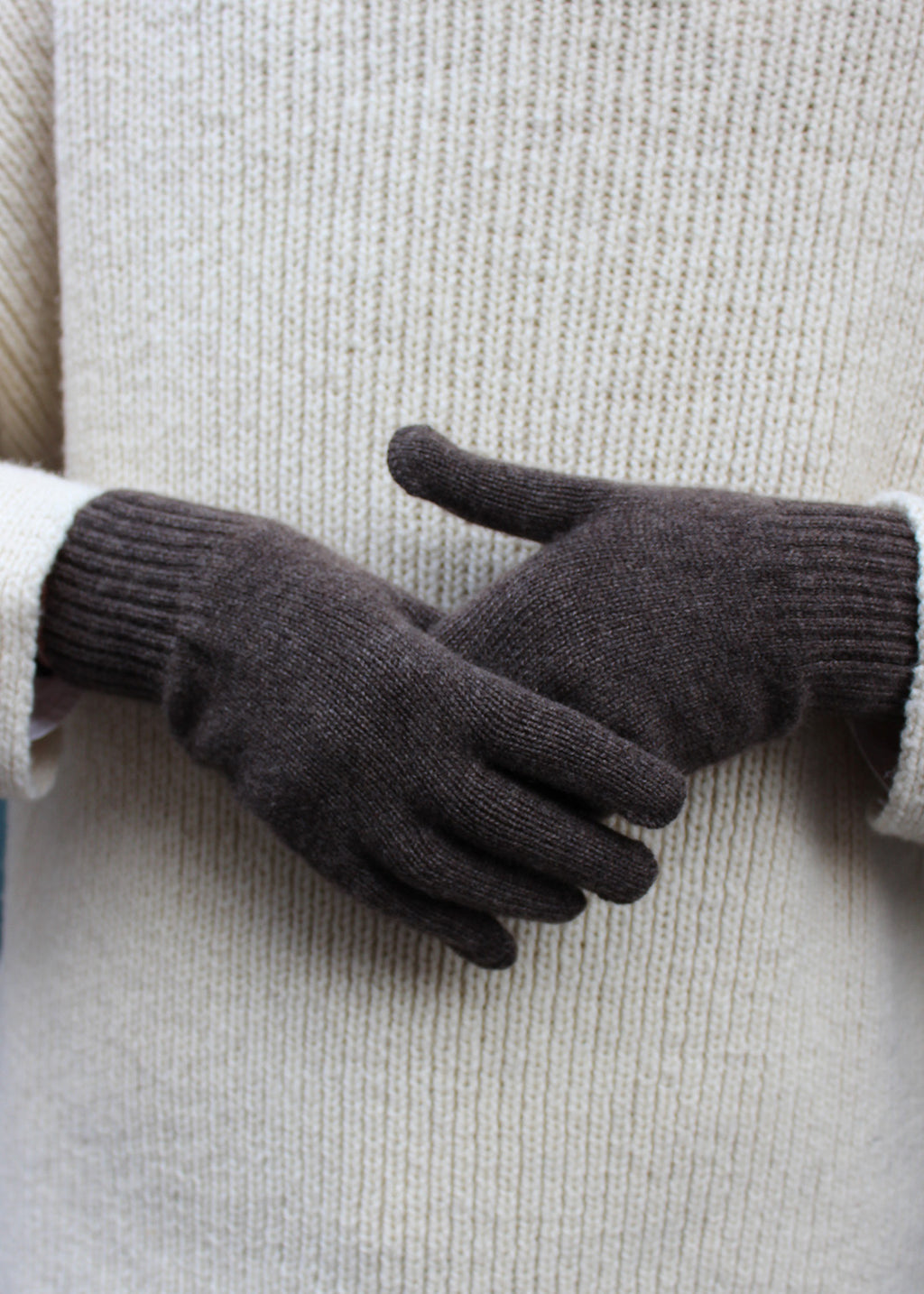 Pair of pepper cashmere gloves on model.