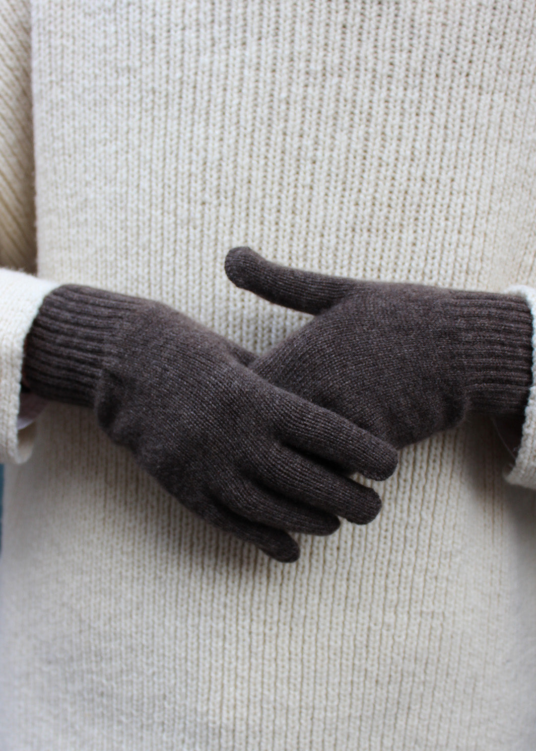 Pair of pepper cashmere gloves on model.