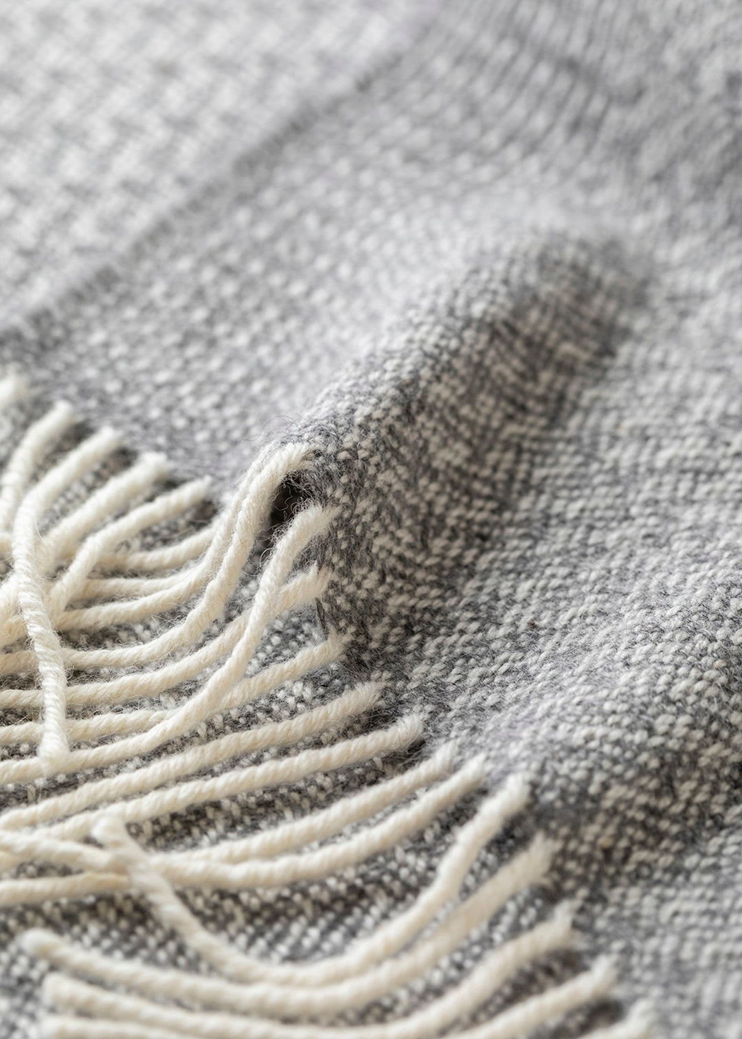 Un-dyed alpaca scarf in grey and off-white, woven in a rippling barley design.