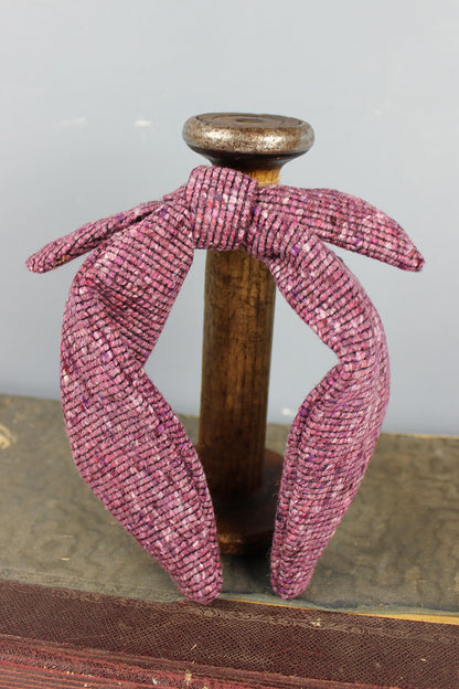 Heather purple tweed headband with bow.