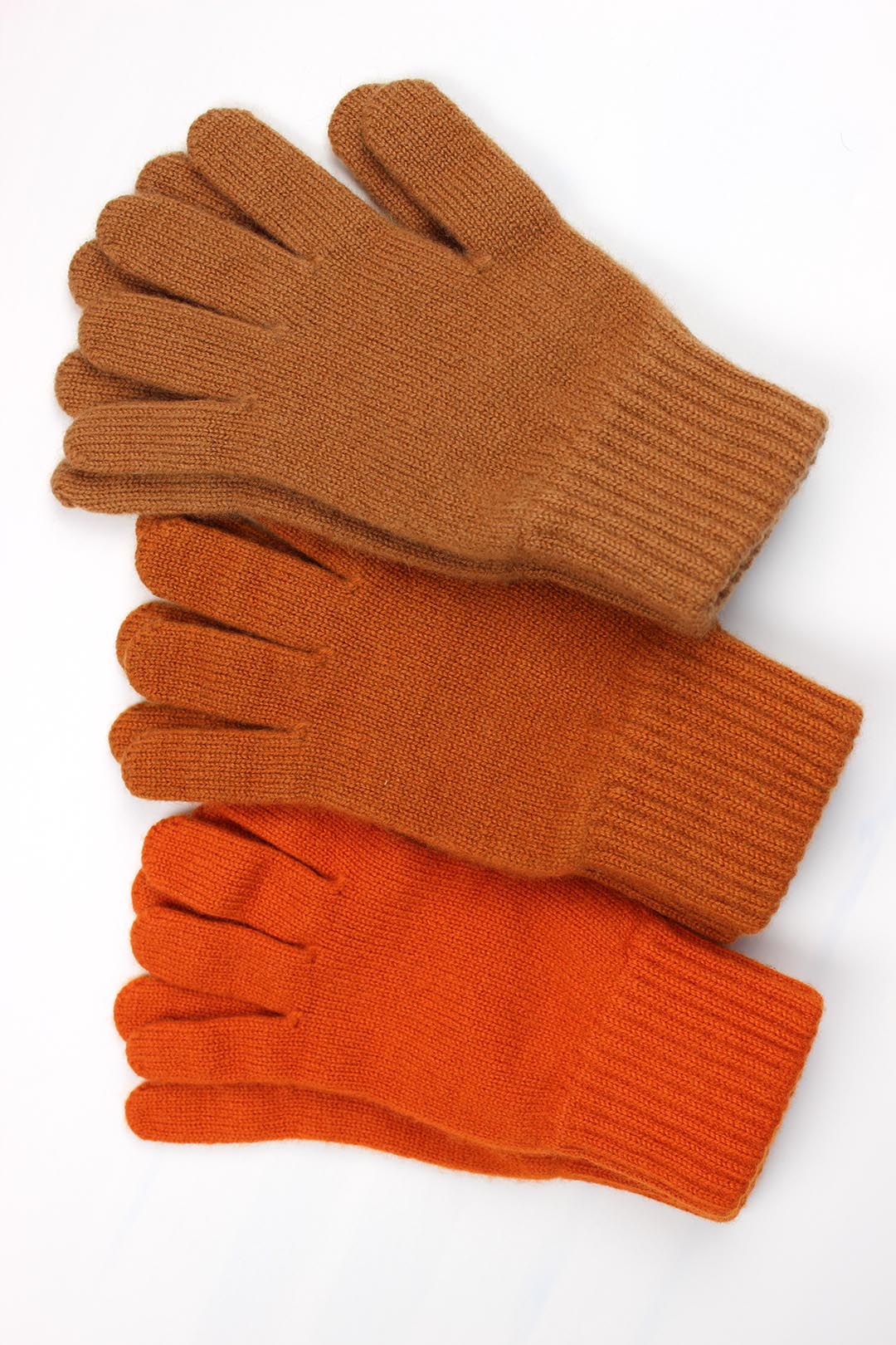 Cashmere gloves in orange shades cinnamon, ginger and pumpkin. Knitted in the Scottish borders