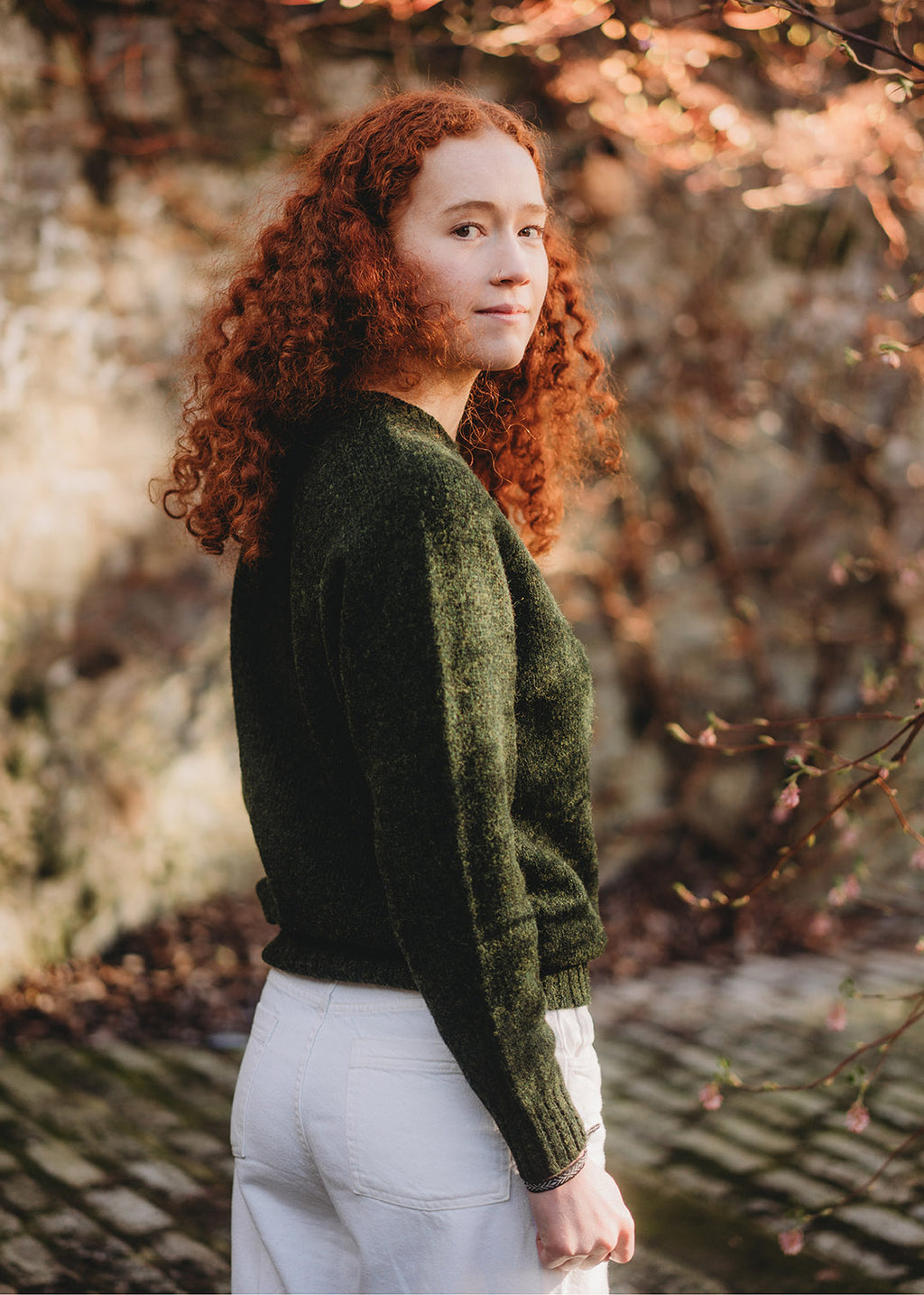 Shetland jumper in pine green shown on model. 