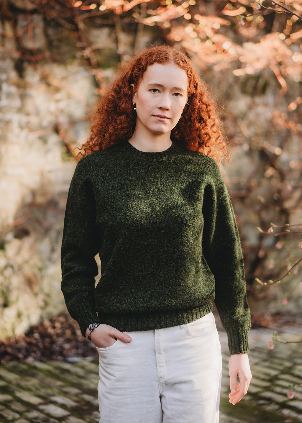 Shetland jumper in pine green shown on model. 