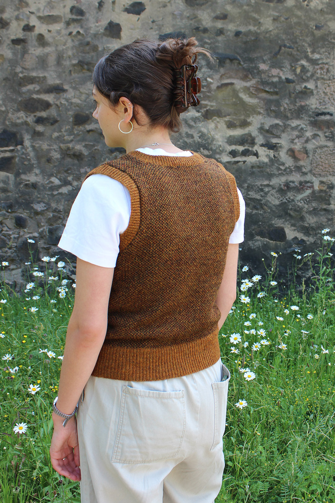 Shetland knitted tank top in burnt umber, with a v-neck. Back of tank top shown.