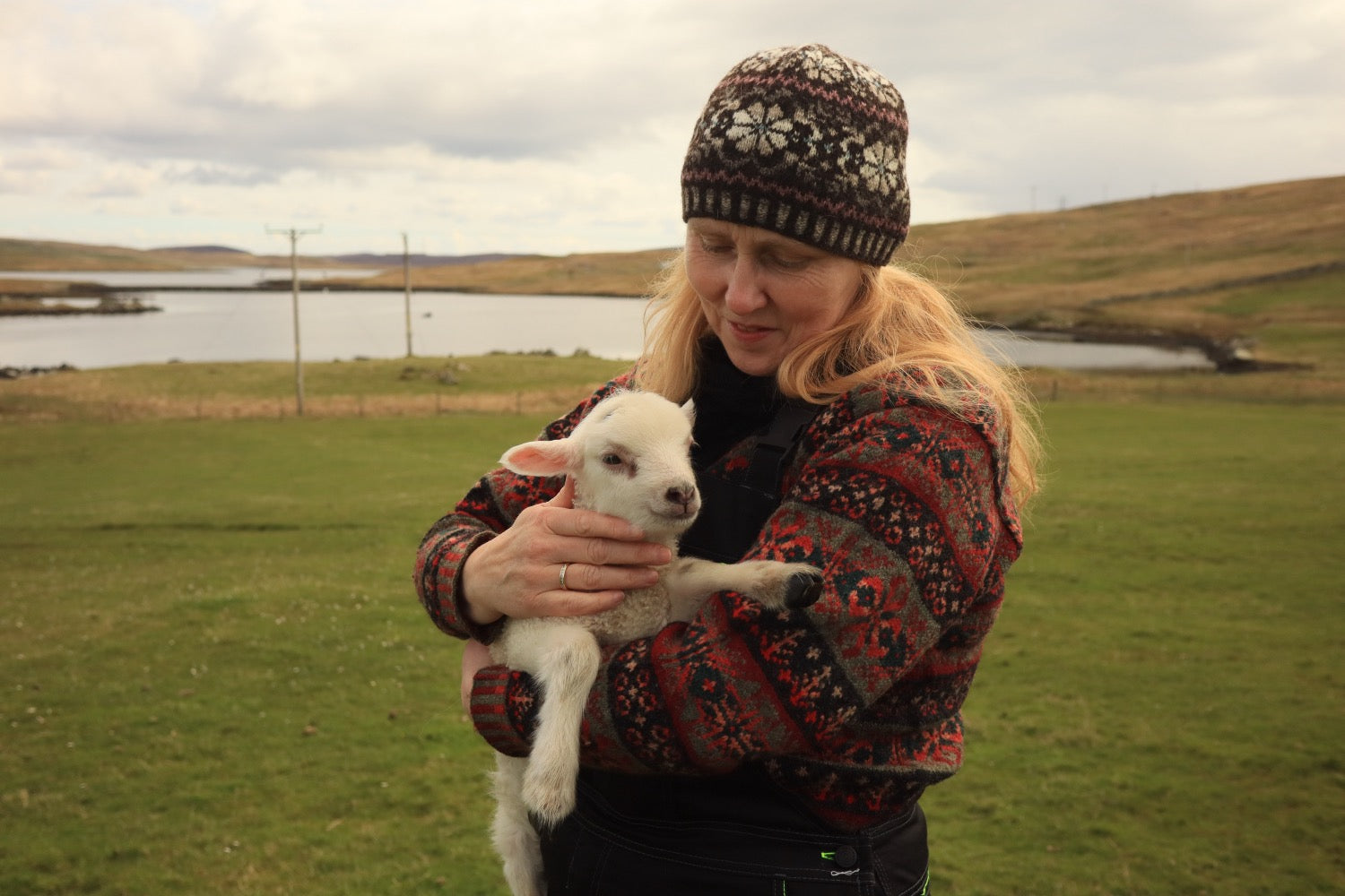 Shetland knitter Alison Rendall with a native Shetland lamb.