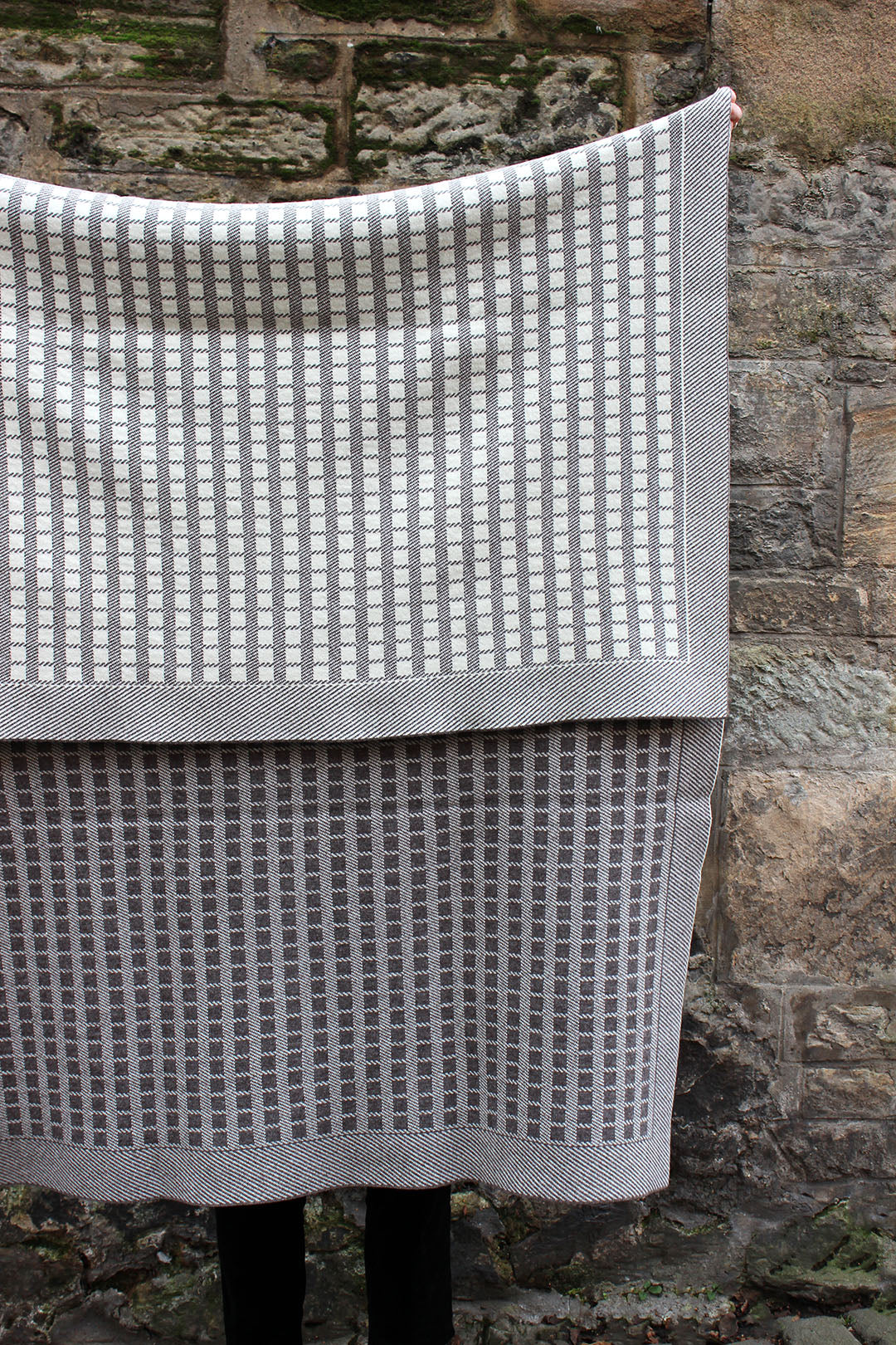 Designed in an exclusive colourway for the Scottish Textiles Showcase, this jacquard knit blanket is inspired by timeless weave structures and knitted in Ayrshire in sumptuously soft lambswool by Hilary Jane Keyes. 